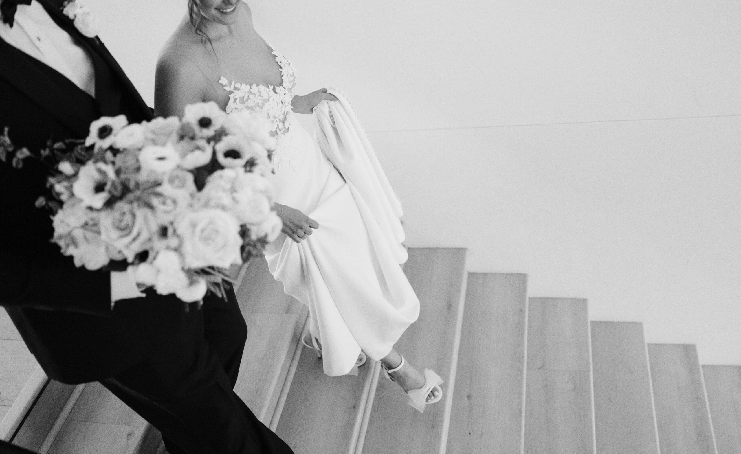 Bride and groom walking down grand staircase